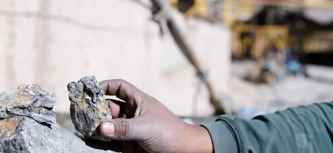 The Cerro Rico hillside and ore silver on the hand in the background of the mining conglomerate