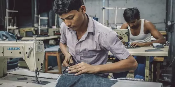 Indian workers sewing