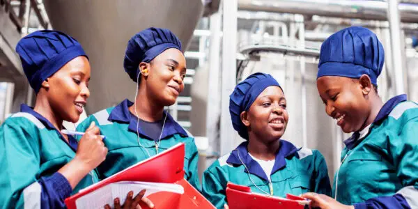 Female factory workers bantering before their shift
