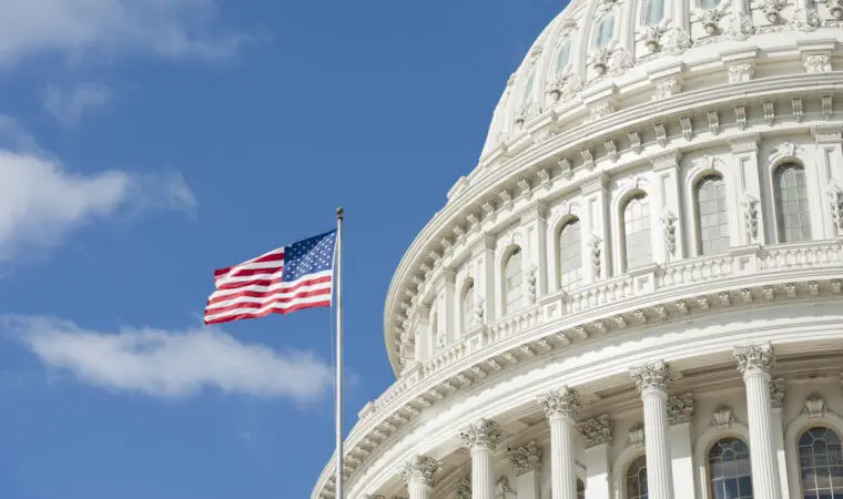 American flag waving in front of Capitol Hill